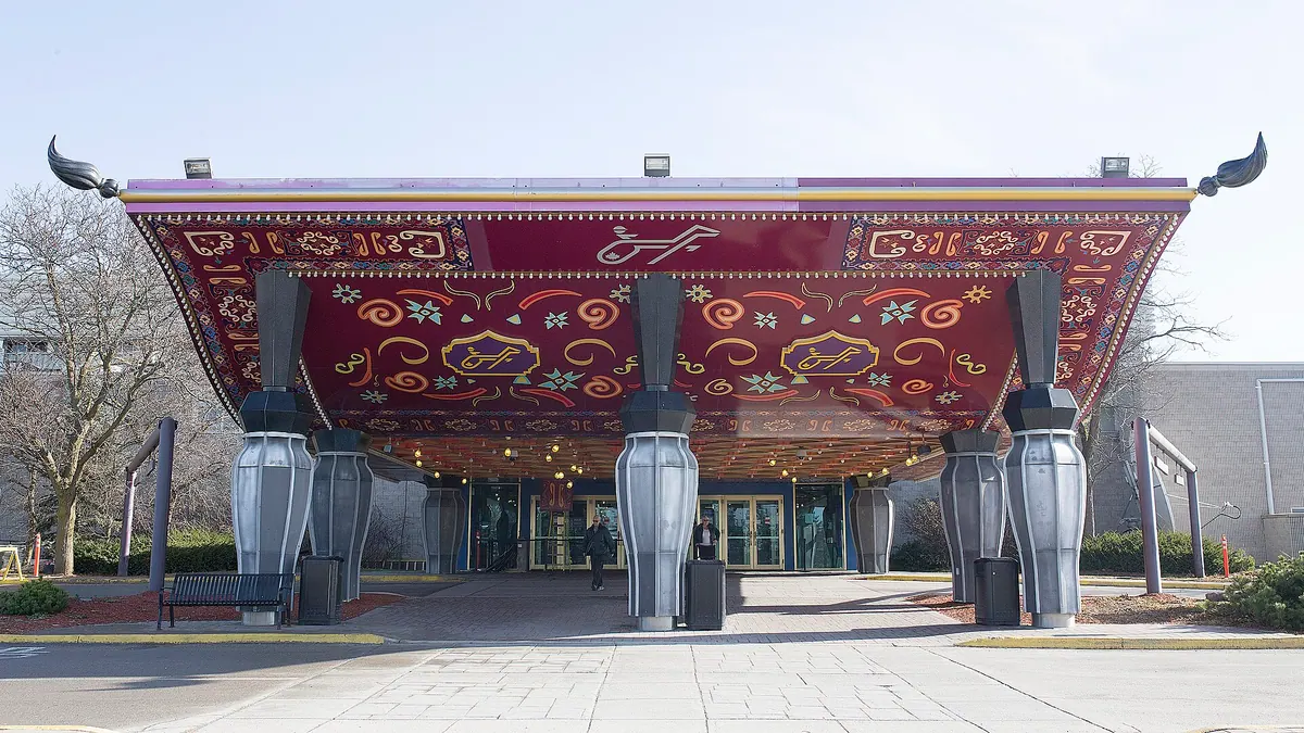 The ornate red entrance canopy of Flamboro Downs, home of Elements Casino Flamboro, on silver vase-shaped columns